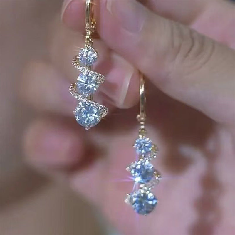Asymmetrical spiral and teardrop earrings